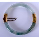 A 19TH CENTURY 14CT GOLD CHINESE JADEITE BANGLE. 6.5 cm diameter.