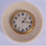 AN EARLY 20TH CENTURY FRENCH EIGHT DAY CARVED IVORY TRAVELLING CLOCK with foliate decoration. 11 cm