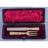 A LATE VICTORIAN CARVED IVORY KNIFE AND FORK SET. 9.5 cm long.