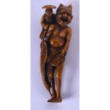 A LARGE 19TH CENTURY JAPANESE MEIJI PERIOD STAINED IVORY NETSUKE modelled as oni with a farmer upon
