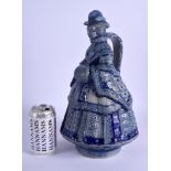 A RARE ANTIQUE GERMAN WESTERWALD POTTERY JUG AND COVER formed as a lady in crinoline clothing. 35 cm