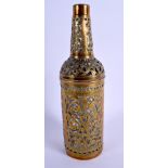 AN EARLY 20TH CENTURY INDIAN BRASS OVERLAID GLASS BOTTLE decorated with foliage and vines. 29 cm hig
