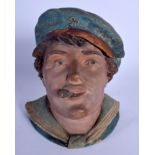 AN ANTIQUE AUSTRIAN TOBACCO JAR AND COVER in the form of smoking sailor. 20 cm high.