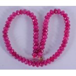 A GOLD TOPPED RUBY NECKLACE. 36 grams. 39 cm long.