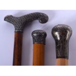 THREE ANTIQUE SILVER MOUNTED WALKING CANES. Largest 84 cm long. (3)