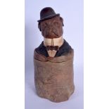 AN ANTIQUE AUSTRIAN TOBACCO JAR AND COVER in the form of dog wearing a suit. 27 cm high.