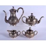 A 19TH CENTURY CHINESE EXPORT SILVER FOUR PIECE TEASET decorated with flowering vines and foliage. 1