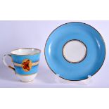 A ROYAL WORCESTER TURQUOISE GROUND CUP AND SAUCER decorated with butterflies in gilt panels and a gi