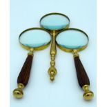 Three vintage magnifying glasses 29cm . (3)