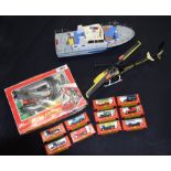 A radio controlled helicopter and Boat together with other models including corgi trucks