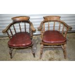 A pair of oak chairs with leather cushions 75 63cm. (2)