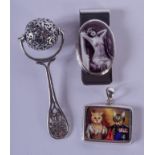 A SILVER RATTLE and a silver money clip & a silver cat pendant. (3)