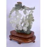 AN EARLY 20TH CENTURY CHINESE CARVED JADEITE FIGURE OF A FEMALE modelled amongst foliage. Jadeite 12