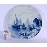 A VERY LARGE CONTINENTAL BLUE AND WHITE POTTERY CHARGER decorated with boating scenes. 45 cm diamete