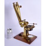 A LARGE JAMES HOW & CO OF LONDON DOUBLE MICROSCOPE upon a wooden plinth. 41 cm high.