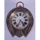 AN ANTIQUE SILVER HORSE SHOE CLOCK. 12 cm x 9 cm.