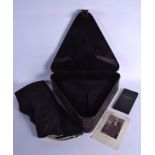 A TIN CASED ANTIQUE TRICORN HAT with cloak. Box 41 cm x 41 cm.