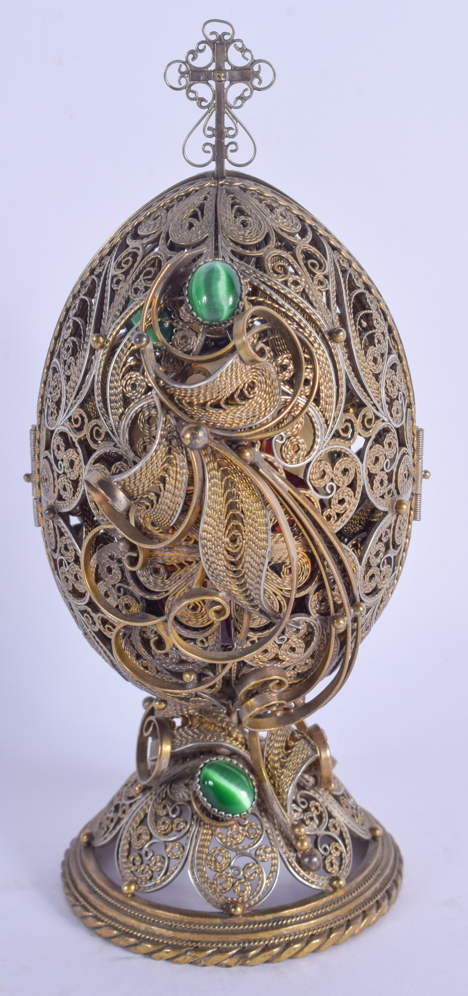 AN EARLY 20TH CENTURY RUSSIAN SILVER GILT JEWELLED EGG revealing a religious icon. 213 grams. 15 cm