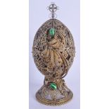 AN EARLY 20TH CENTURY RUSSIAN SILVER GILT JEWELLED EGG revealing a religious icon. 213 grams. 15 cm
