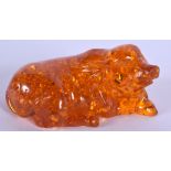 A CHINESE CARVED AMBER FIGURE OF A PIG 20th Century. 136 grams. 9 cm wide.