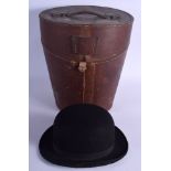 AN ANTIQUE LEATHER CASED WILSON BOWLER HAT. Hat interior 21 cm x 14 cm. (2)