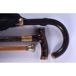 A VINTAGE TORTOISESHELL HANDLED CANE together with two others. Largest 88 cm long. (3)