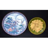 A large Japanese plate decorated with a boat and foliage and another plate 32cm. (2)