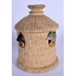 AN ANTIQUE AUSTRIAN TOBACCO JAR AND COVER in the form of heads within a hut. 19 cm high.