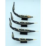 A group of carved wooden boats with African Ivory figures 22 cm (4).