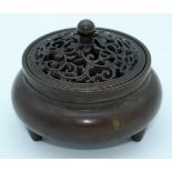 A small Chinese bronze censer with an openwork lid 10 x 7cm.