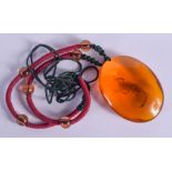 A LARGE AMBER NECKLACE. Amber 5 cm x 3.5 cm.
