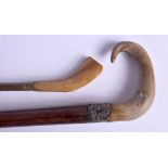A 19TH CENTURY CONTINENTAL CARVED RHINOCEROS HORN HANDLED CANE together with a Rhinoceros horn handl