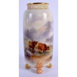 A ROYAL WORCESTER VASE with pierced neck supported on for feet, painted with Highland Cattle by H. S