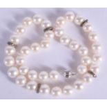 AN 18CT GOLD DIAMOND AND PEARL NECKLACE. 69 grams. 44 cm long.