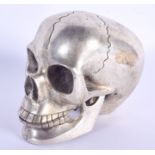 A CONTEMPORARY SILVER PLATED SKULL. 11 cm x 9 cm.