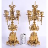A PAIR OF 19TH CENTURY FRENCH BRONZE CANDLESTICKS formed with paw feet and acanthus. 43 cm x 15 cm.