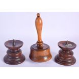 A PAIR OF ANTIQUE TREEN PRICKET CANDLESTICKS and a mallet. Largest 18 cm high. (3)