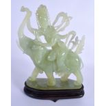 AN EARLY 19TH CENTURY CHINESE CARVED JADE FIGURE OF AN ELEPHANT modelled being ridden by a buddhisti