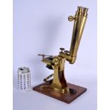 A LARGE JAMES HOW & CO OF LONDON DOUBLE MICROSCOPE upon a wooden plinth. 41 cm high.