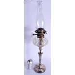AN ANTIQUE SILVER PLATED OIL LAMP. 45 cm high not inc funnel.