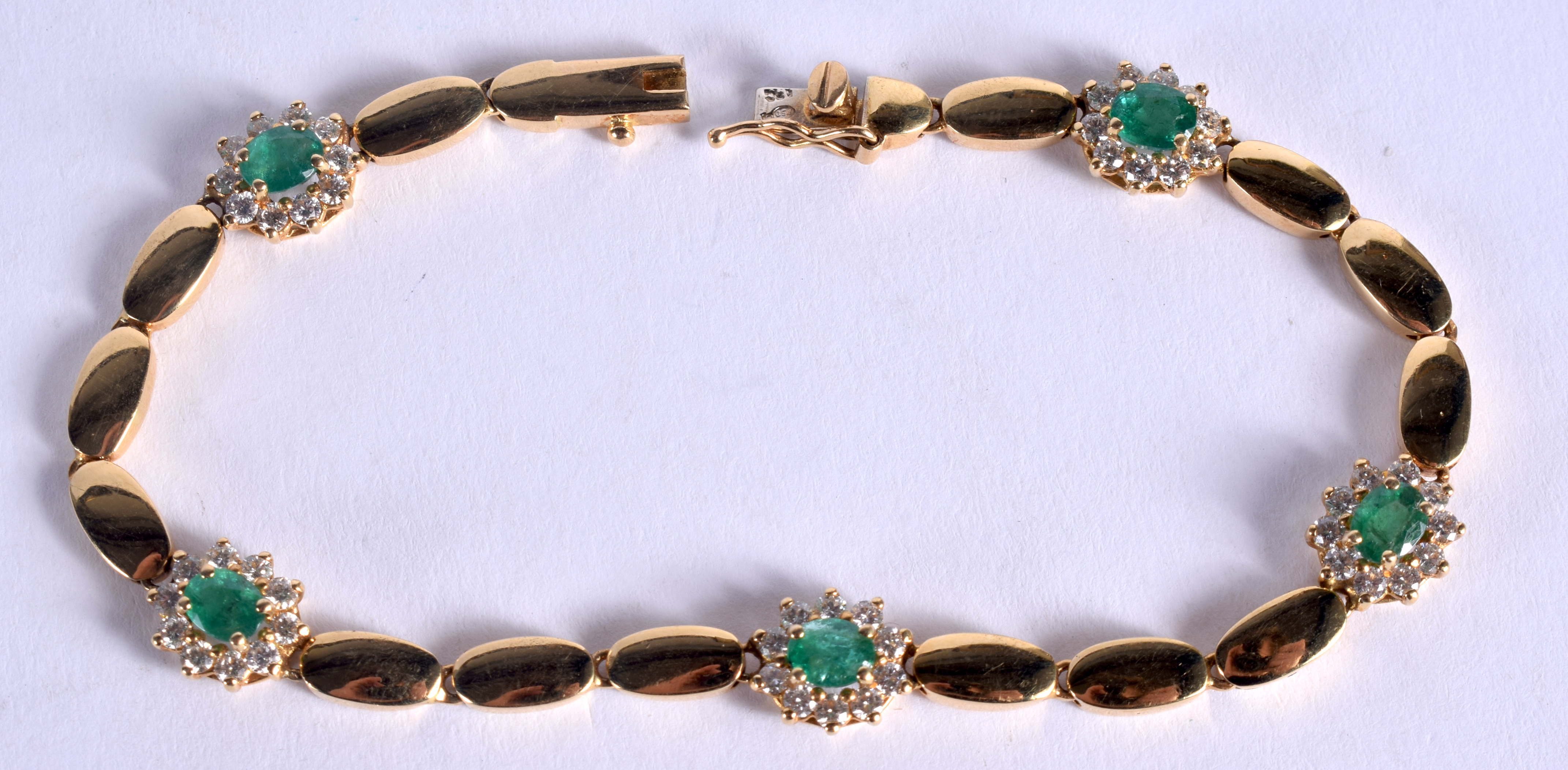 AN 18CT GOLD DIAMOND AND EMERALD BRACELET. 13 grams. 18 cm long.