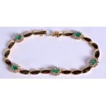 AN 18CT GOLD DIAMOND AND EMERALD BRACELET. 13 grams. 18 cm long.