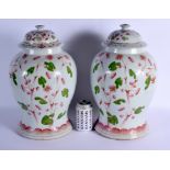A VERY RARE PAIR OF MID 19TH CENTURY CHINESE FAMILLE ROSE VASES AND COVERS Qing, unusually painted w