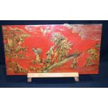 A Chinese lacquered wooden panel depicting people in a rural pursuits 41 x 76cm..