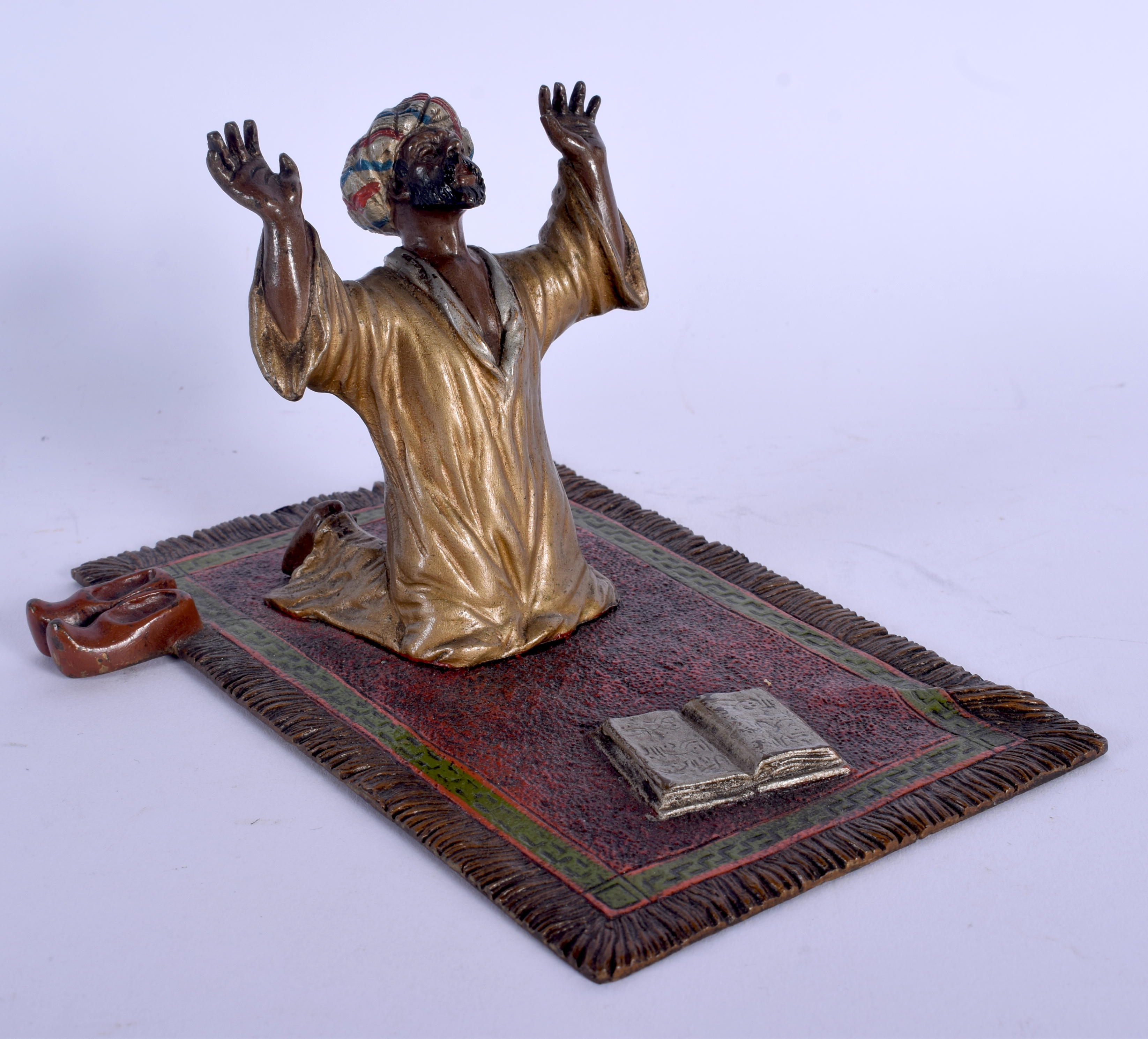 A 19TH CENTURY AUSTRIAN COLD PAINTED BRONZE FIGURE OF AN ARABIC MALE modelled praying. 15 cm x 8 cm.