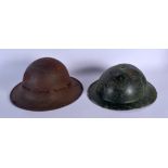 TWO MILITARY HELMETS. 27 cm wide. (2)