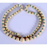 AN ANTIQUE IVORY AND TURQUOISE NECKLACE. 70 cm long.