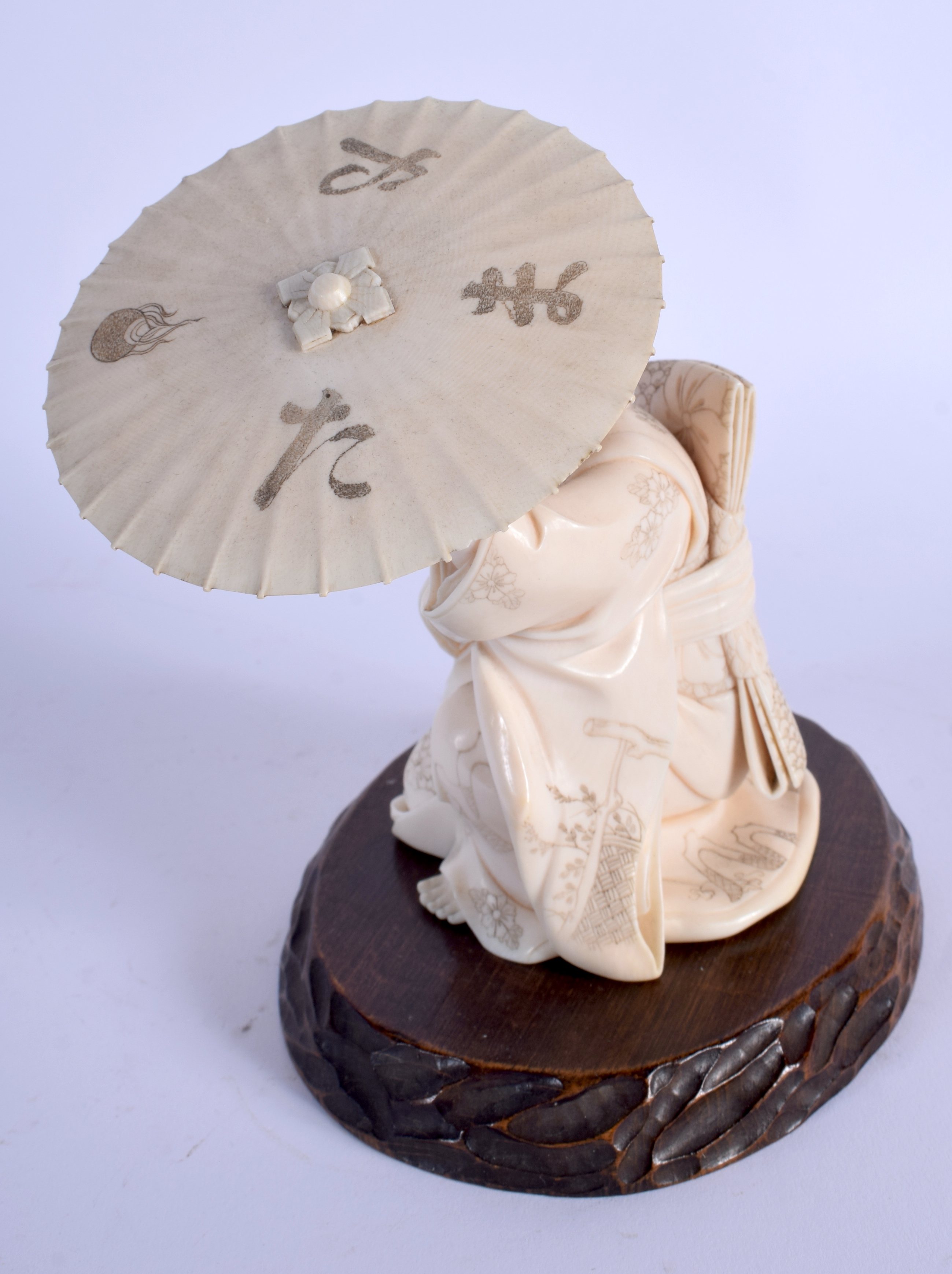 A FINE 19TH CENTURY JAPANESE MEIJI PERIOD CARVED IVORY OKIMONO modelled as a female sheltering under - Image 2 of 4