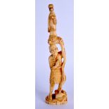 A 19TH CENTURY JAPANESE MEIJI PERIOD CARVED IVORY OKIMONO modelled holding aloft a female. 23.5 cm h