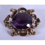 A LARGE ANTIQUE YELLOW METAL AND AMETHYST BROOCH. 9 grams. 3.5 cm x 2.5 cm.